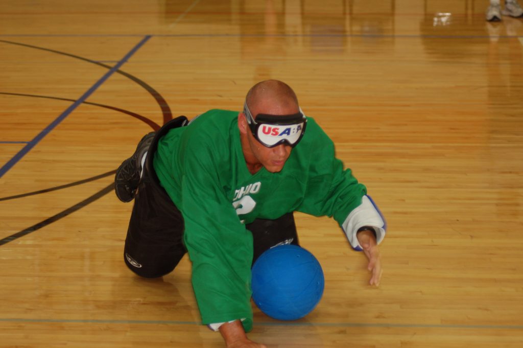 Man crawling while playing Goalballl